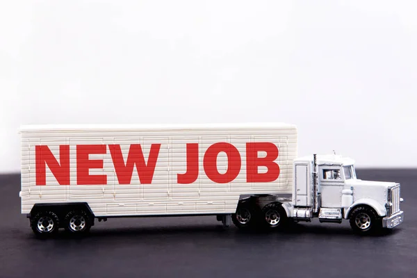 New Job word concept written on board a lorry trailer on a dark table and light background