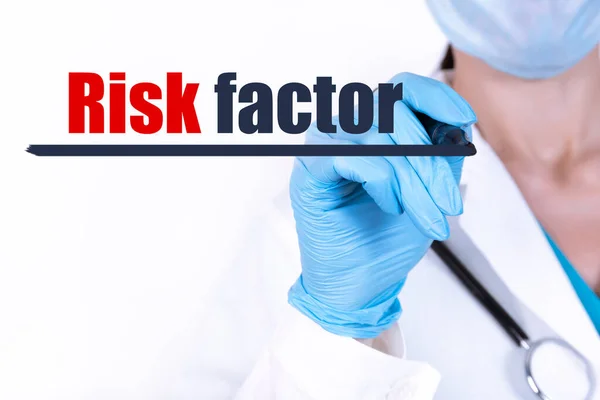 RISK FACTOR text written by a doctor hand with a stethoscope. medical concept.