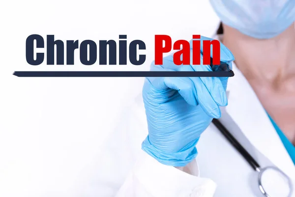 CHRONIC PAIN text written by a doctor hand with a stethoscope. medical concept.