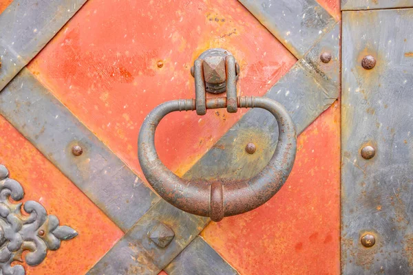 Round forged handle on the entrance gate of the castle.