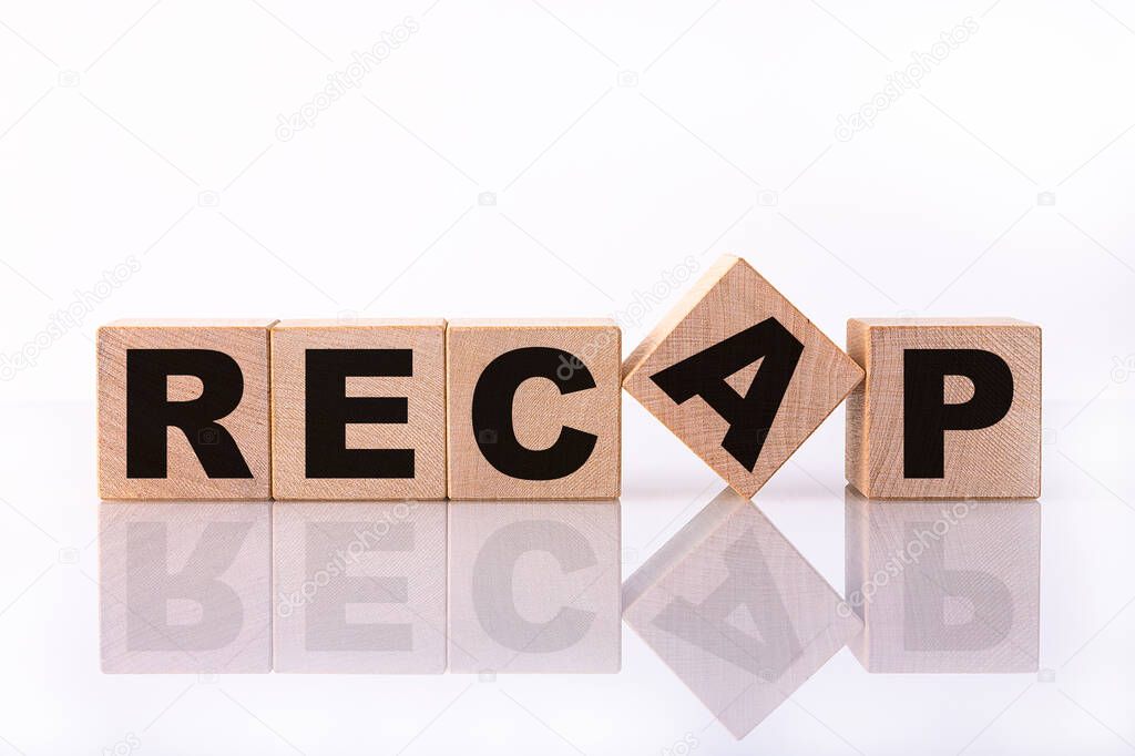 RECAP word, text written on wooden cubes on a white background with reflection.