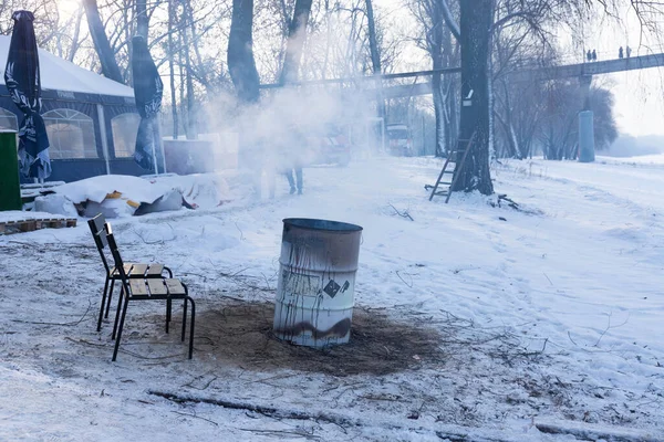 Fire in a barrel for cold winter weather. Refugees, illegal immegrents, homelesses burn a fire in barrel to warm up.