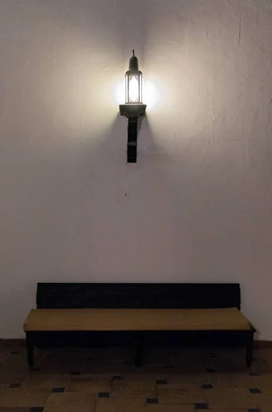 wall lamp at night outdoors, lamp on brick wall at night