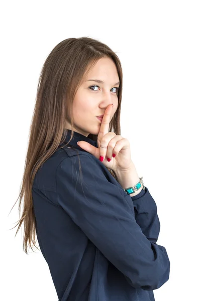 Chica de cabello castaño en una camisa presiona un dedo a sus labios — Foto de Stock