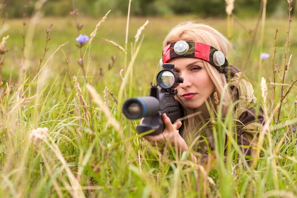 Woman looking into the optical sight — Stock Photo, Image