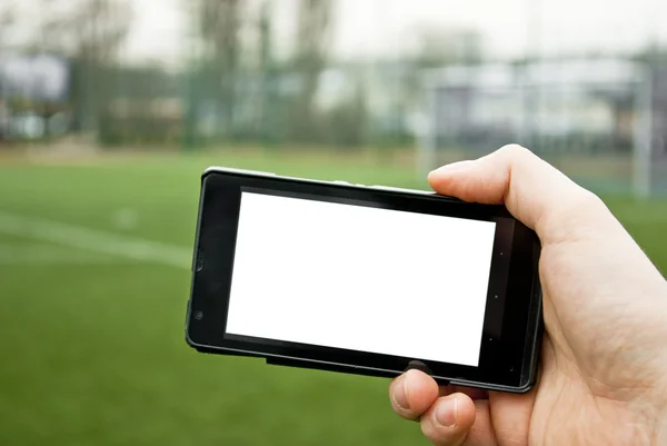 智能手机和足球场上 — 图库照片