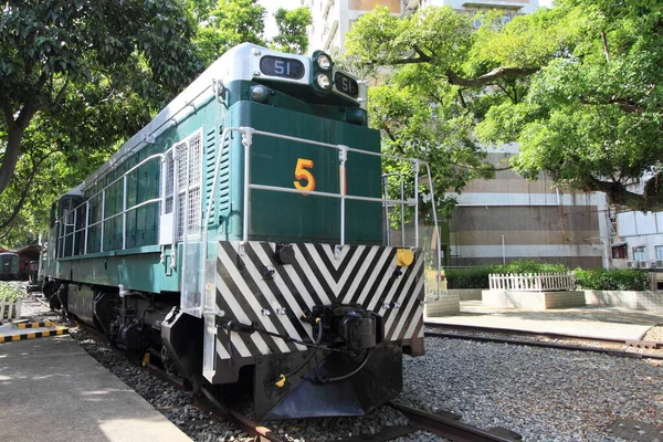 HONG KONG -JULY 16, 2014: Retired historical green train at Tai Po on July 16, 2014 in Hong Kong. This historical diesel locomotive is parked at the only railway museum in Hong Kong.