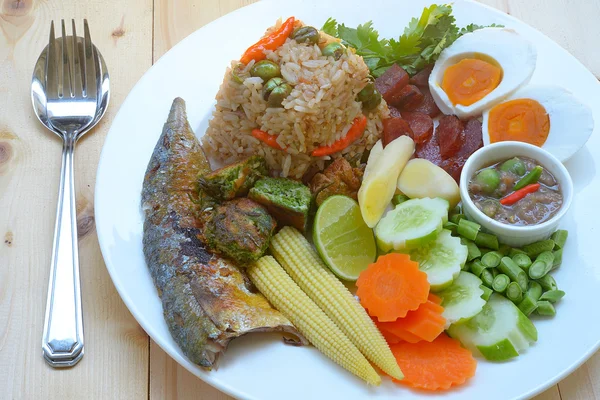 Thai fried rice served with mackerel, salted egg and vegetable