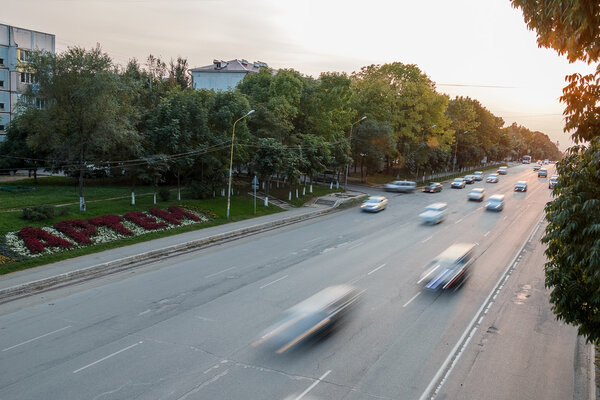 The movement of cars on the central street. Russia, city of Artyom