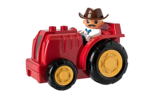 Children's tractor with the farmer in a hat — Stock Photo, Image