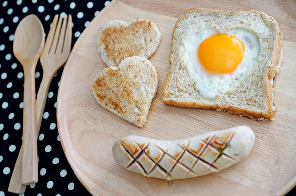 Breakfast consist of toast with fried egg in shape of heart and ロイヤリティフリーのストック画像
