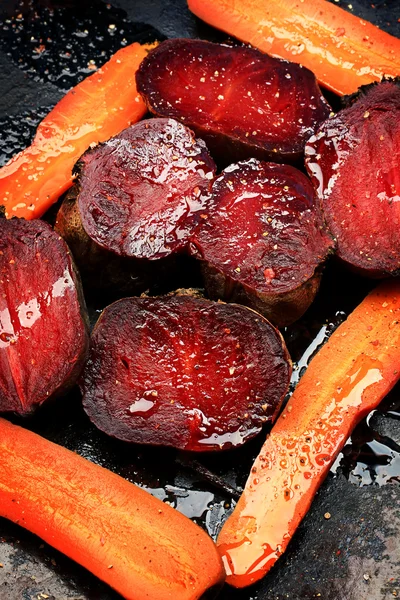 roasted vegetables beets carrots dark background selective focus toning rustic old style