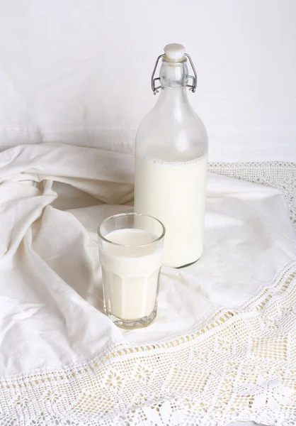 glass of milk  bottle  white linen background rustic style advertising eco products