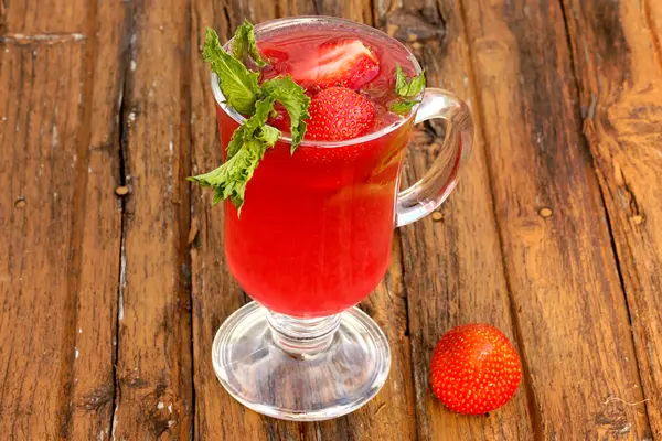 Strawberry drink from fresh berries with mint on an old wooden background rustic style of cooking at home — Stock Photo, Image