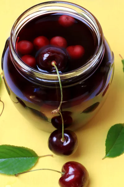 Cherry juice on a yellow wooden background flat top over head view cover cookbook — Stock Photo, Image