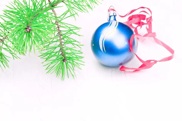 Christmas background with a soft focus branch of fir-tree ball — Stock Photo, Image