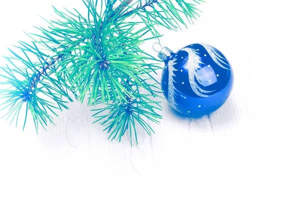 Christmas background with a soft focus branch of fir-tree ball — Stock Photo, Image