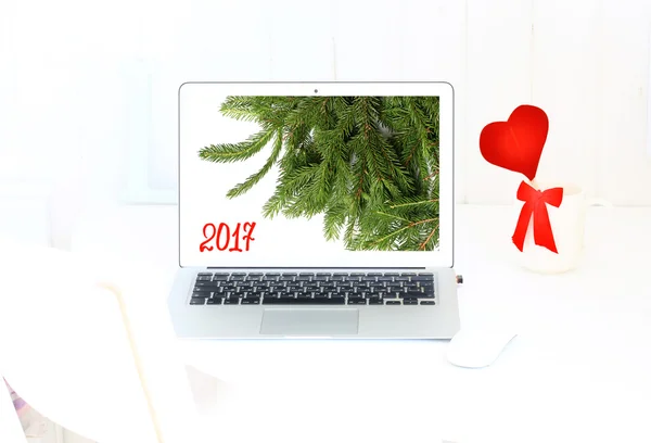 New Year background Christmas tree Laptop in a white room house workplace 2017 — Stock Photo, Image