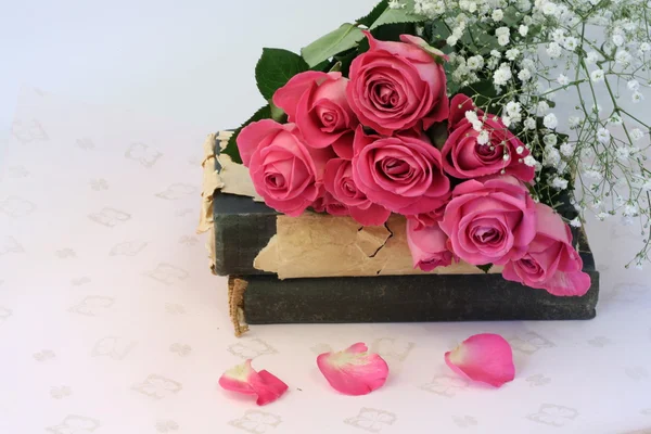 bouquet of pink roses on old books floral background is love tenderness vintage retro selective soft focus