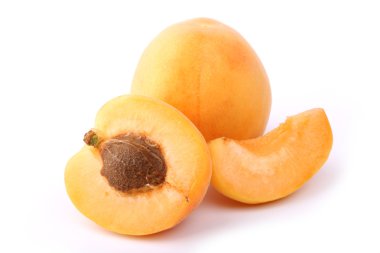 Apricot cut with cinnamon isolated on white background