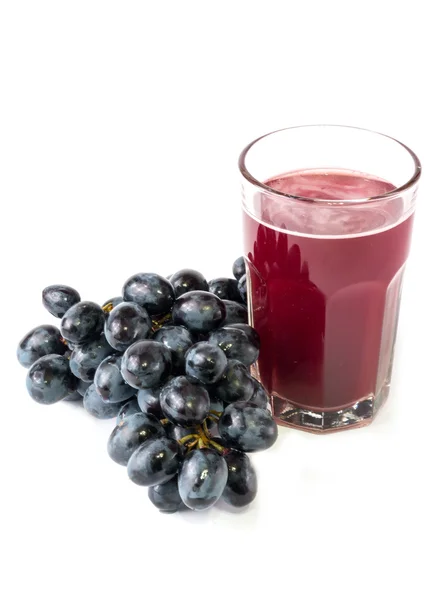 Black grapes glass of grape juice white background — Zdjęcie stockowe