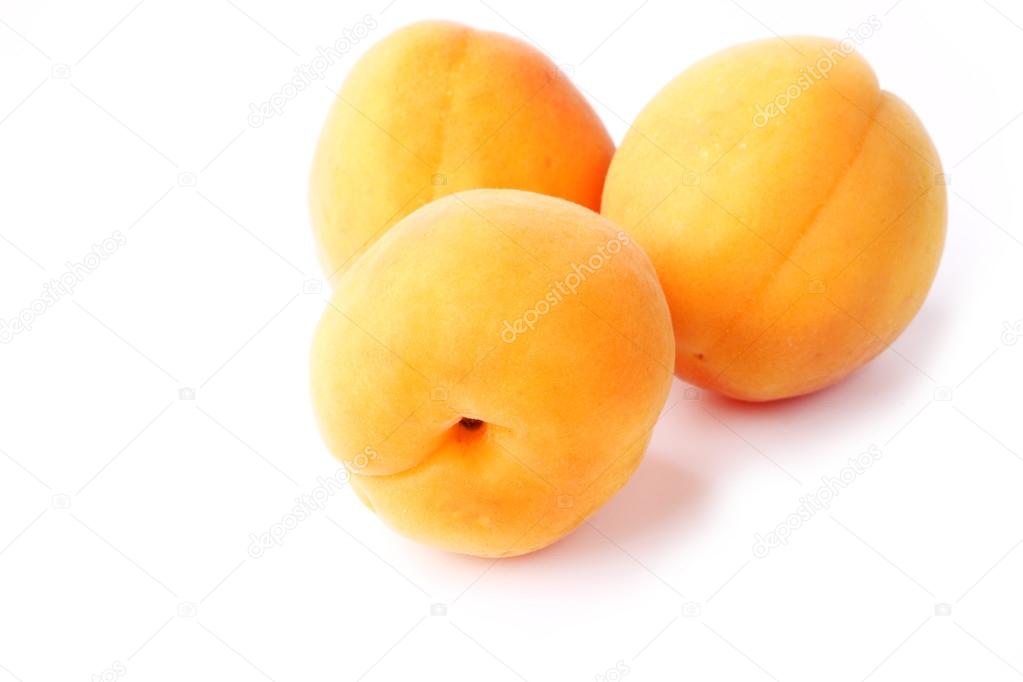 Three apricots isolated on a white background farm organic product