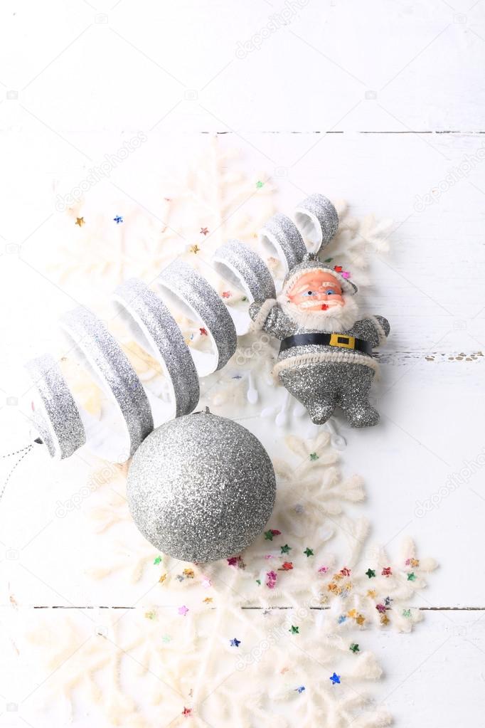 Christmas greeting card Santa New Year toys on a white wooden background