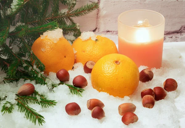 tangerines in snow under a Christmas tree Christmas winter