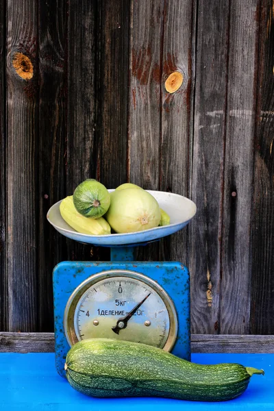 Vintage scales courgettes on dark wooden background rustic farm products — Stock Photo, Image