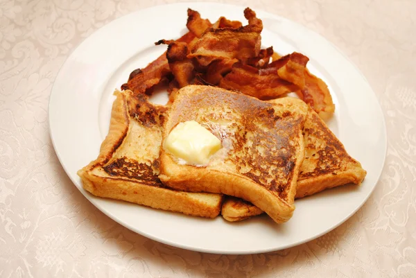 French Toast with Butter Served with a Side of Crispy Bacon — Stock Photo, Image