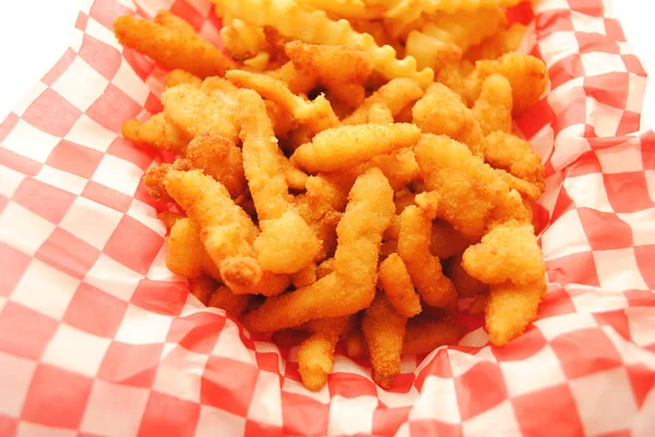 Fast-Food-Mahlzeit aus gebratenen Venusmuscheln und Pommes im Hintergrund — Stockfoto