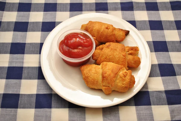 Fish Sticks Wrapped in Golden Croissant Rolls Served with Catsup — Stock Photo, Image