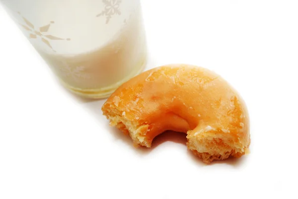 A Half Eaten Doughnut with a Glass of Milk — Stock Photo, Image
