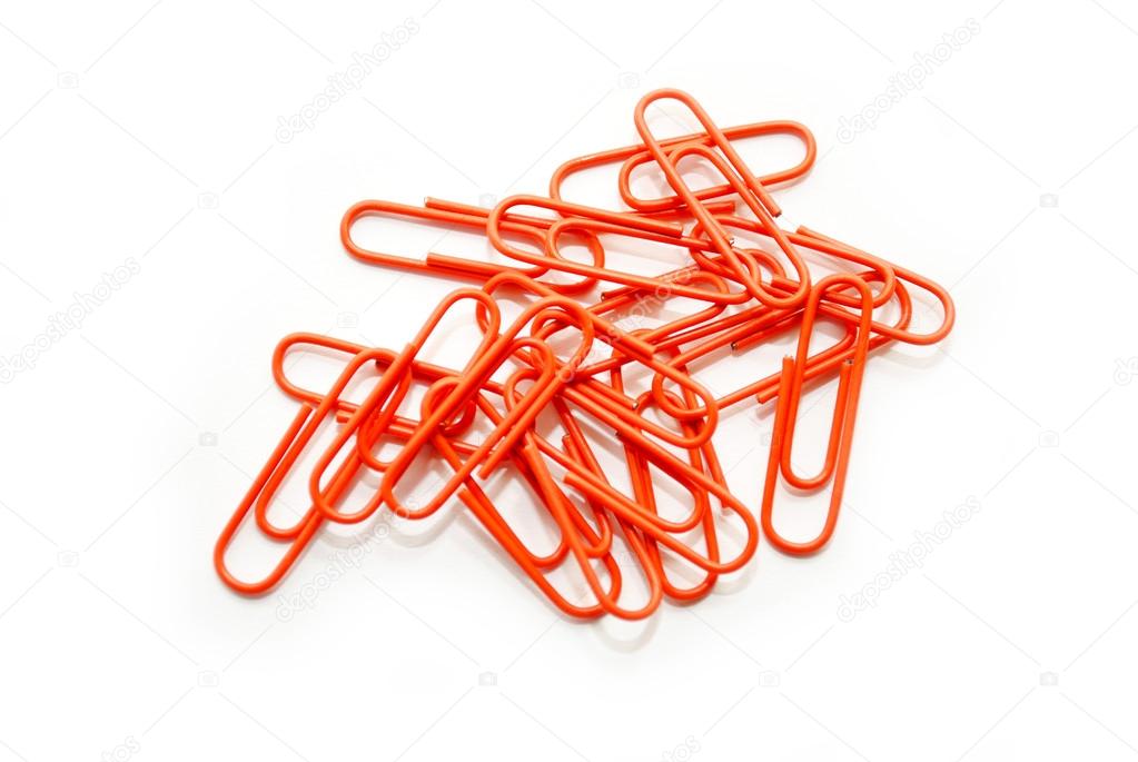 Bright Orange Paperclips Scattered on a White Background