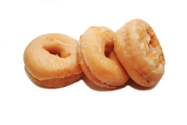 Três donuts vitrificados isolados em um fundo branco — Fotografia de Stock