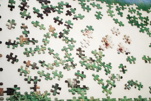 Building a Puzzle That is Laid Out on a Table — Stock Photo, Image