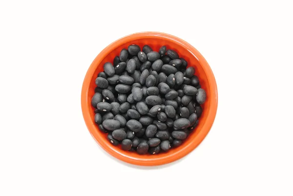 Dry Black Beans in an Orange Bowl Over White — Stock Photo, Image