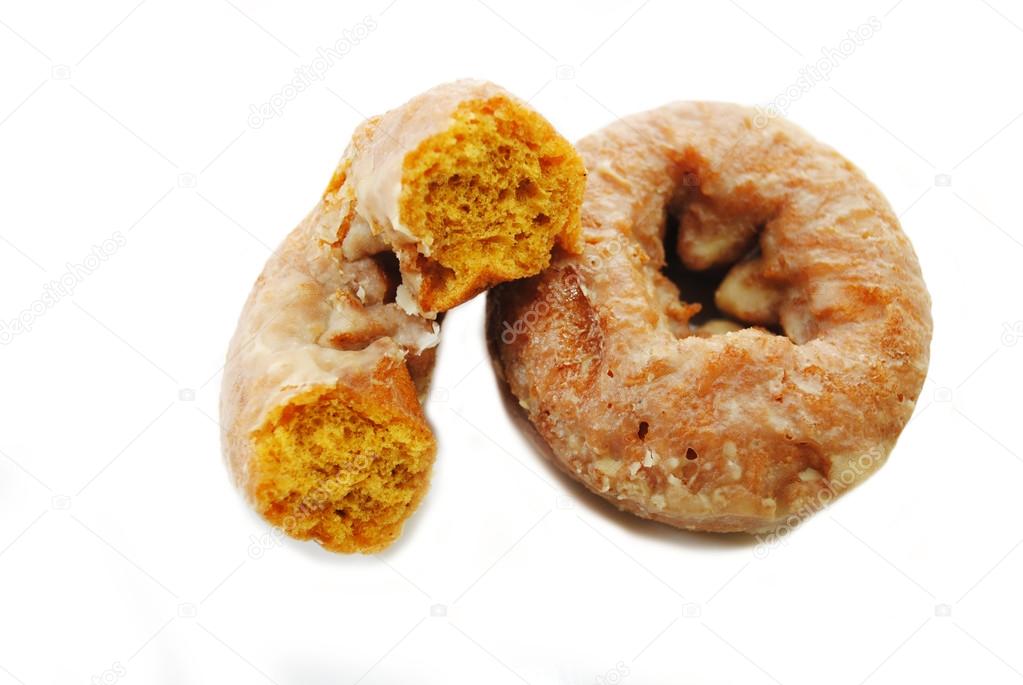 Half of a Pumpkin Donut Leaning on a Whole Donut