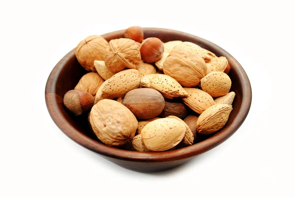 Mixed Whole Nuts in a Wooden Bowl Over White — Stock Photo, Image