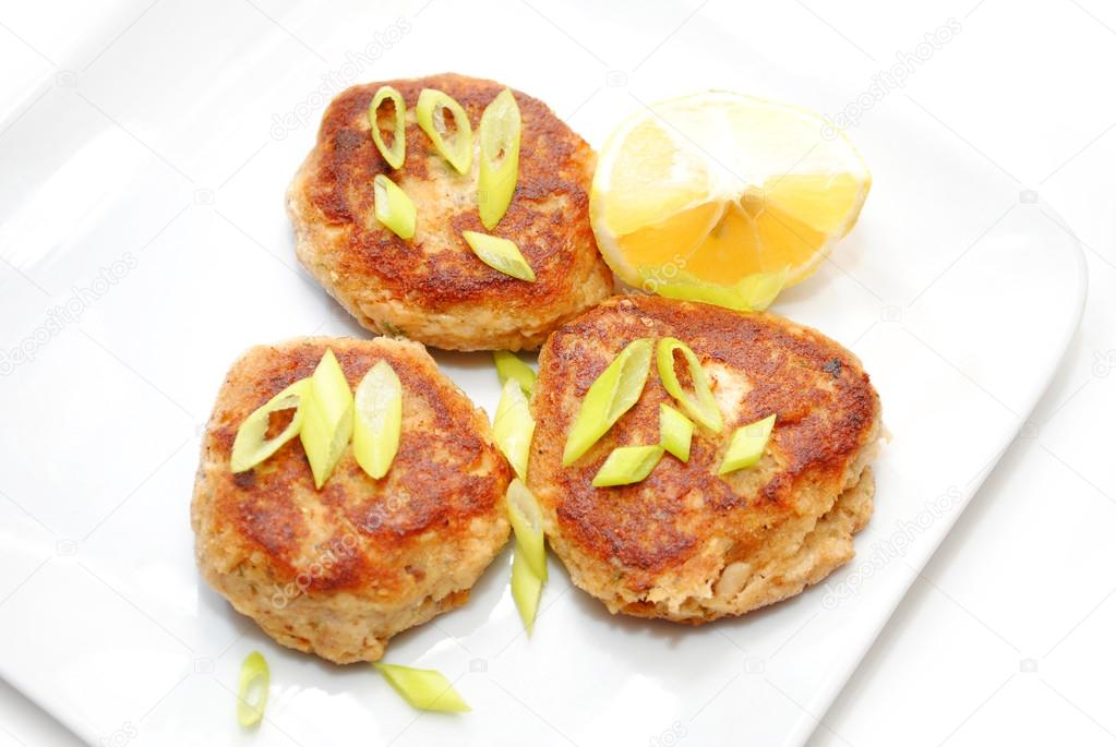 Fish Cakes Served with Lemon and Scallions