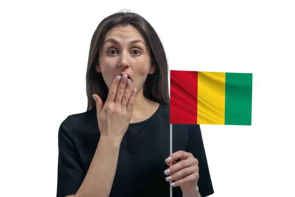 Happy Young White Woman Holding Flag Guinea Covers Her Mouth — Stock fotografie