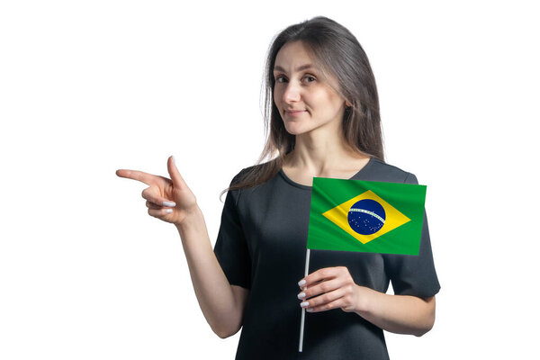 Happy young white woman holding flag Brazil and points to the left isolated on a white background.