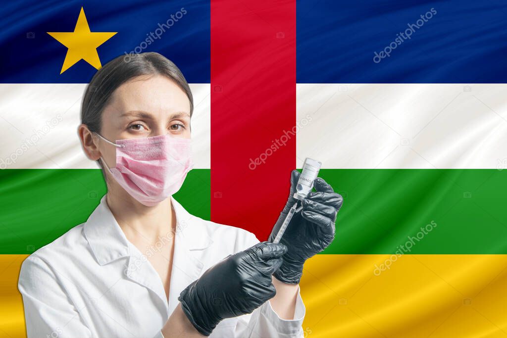 Girl doctor prepares vaccination against the background of the Central African Republic flag. Vaccination concept Central African Republic.