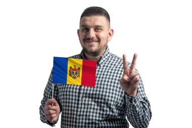 Beyaz adam Moldova bayrağını tutuyor ve beyaz arka planda iki parmak gösteriyor..