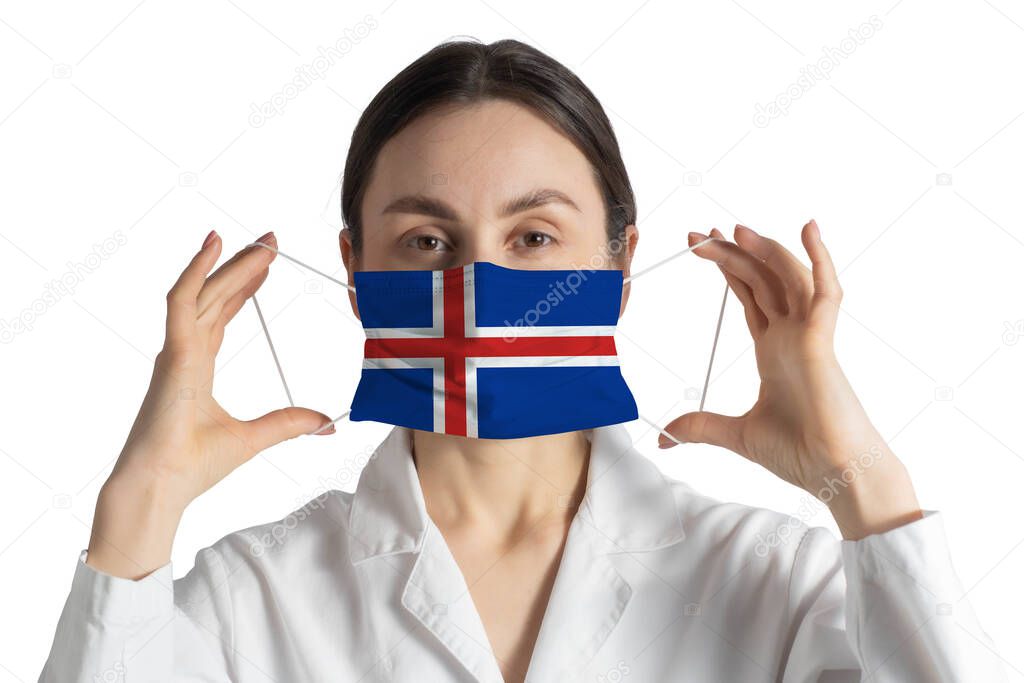 Respirator with flag of Iceland Doctor puts on medical face mask isolated on white background.