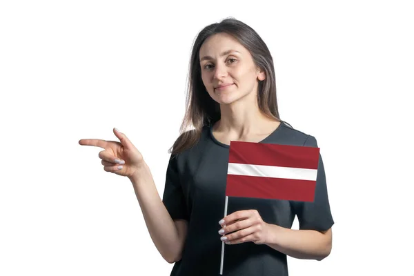 Happy Young White Woman Holding Flag Latvia Points Left Isolated — Stock Photo, Image