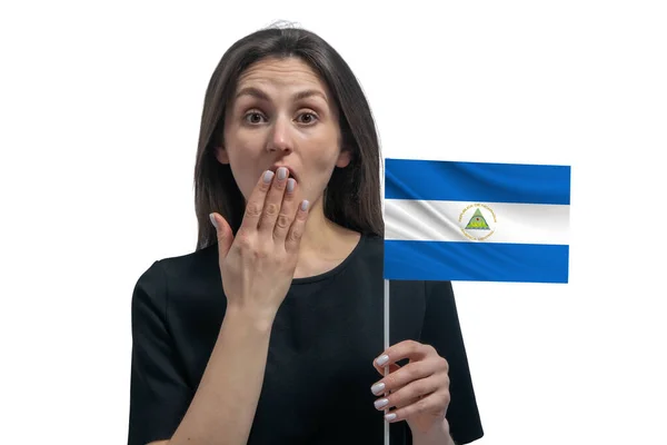 快乐的年轻白人妇女举着尼加拉瓜国旗 用手捂住嘴 双手被白色的背景隔开 — 图库照片