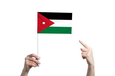 Güzel bir kadın eli Jordan bayrağını tutuyor ve diğer elinin beyaz arka planda izole edilmiş parmağını gösteriyor..