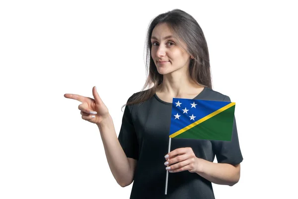 Happy Young White Woman Holding Flag Solomon Islands Points Left — Stock Photo, Image