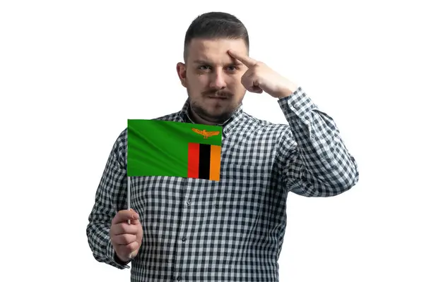 White Guy Holding Flag Zambia Finger Touches Temple Head Isolated — Stockfoto